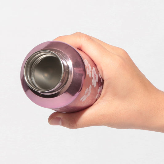 Starbucks Japan SAKURA Shine Brightly 2026 collection merchandise. Limited edition series featuring glitter pink stainless bottles, Stanley collaboration tumblers in pink gradient, and color-changing cups. The design theme highlights vivid spring colors, metallic gold accents, and bright cherry blossom patterns.