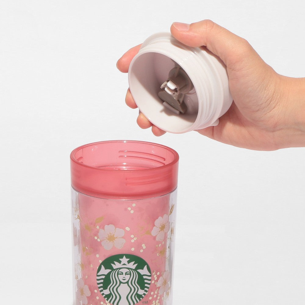 Starbucks Japan SAKURA Shine Brightly 2026 collection merchandise. Limited edition series featuring glitter pink stainless bottles, Stanley collaboration tumblers in pink gradient, and color-changing cups. The design theme highlights vivid spring colors, metallic gold accents, and bright cherry blossom patterns.