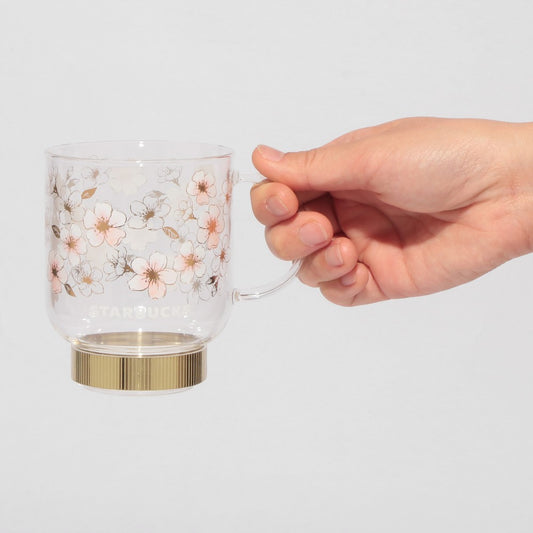 Starbucks Japan SAKURA Shine Brightly 2026 collection merchandise. Limited edition series featuring glitter pink stainless bottles, Stanley collaboration tumblers in pink gradient, and color-changing cups. The design theme highlights vivid spring colors, metallic gold accents, and bright cherry blossom patterns.