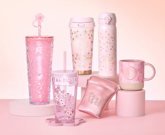 A promotional banner for the Starbucks Japan "SAKURA Shiny Bright" collection. The image features a dazzling array of pink merchandise under bright lighting to emphasize the "shiny" theme.