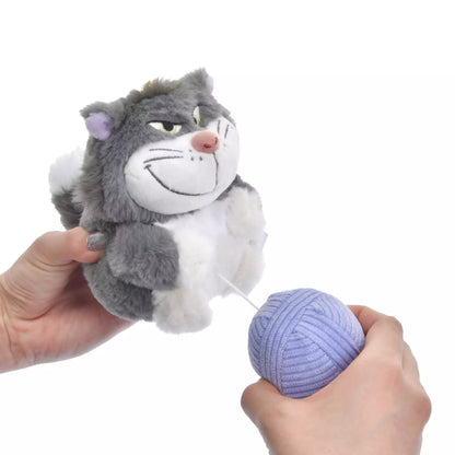 Lucifer and Figaro plush keychains from the Disney Cat Day 2026 series. Fluffy stuffed animal keychains holding a yarn ball or mouse toy. These interactive plushies vibrate when the pull-string toy is pulled.